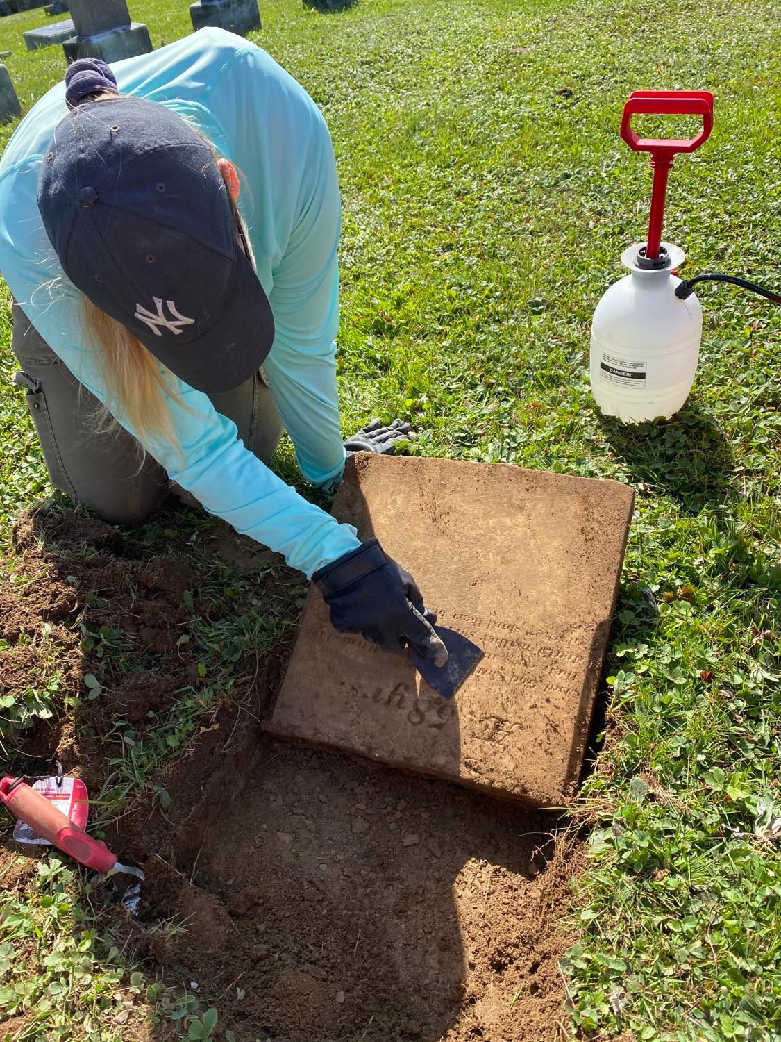 Scraping unearthed gravestone