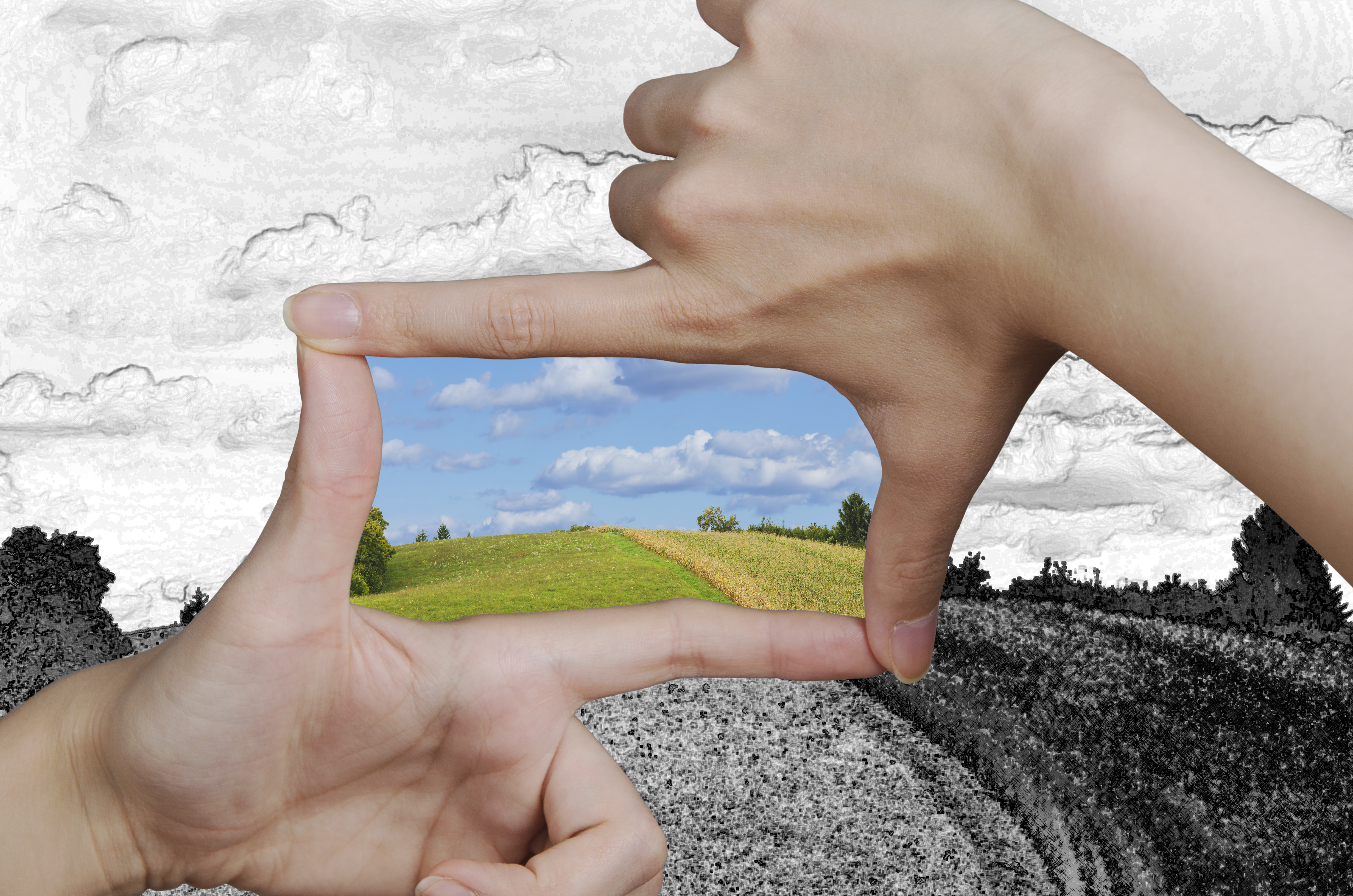 hands creating a square turning a drawing of a clean landscape into reality