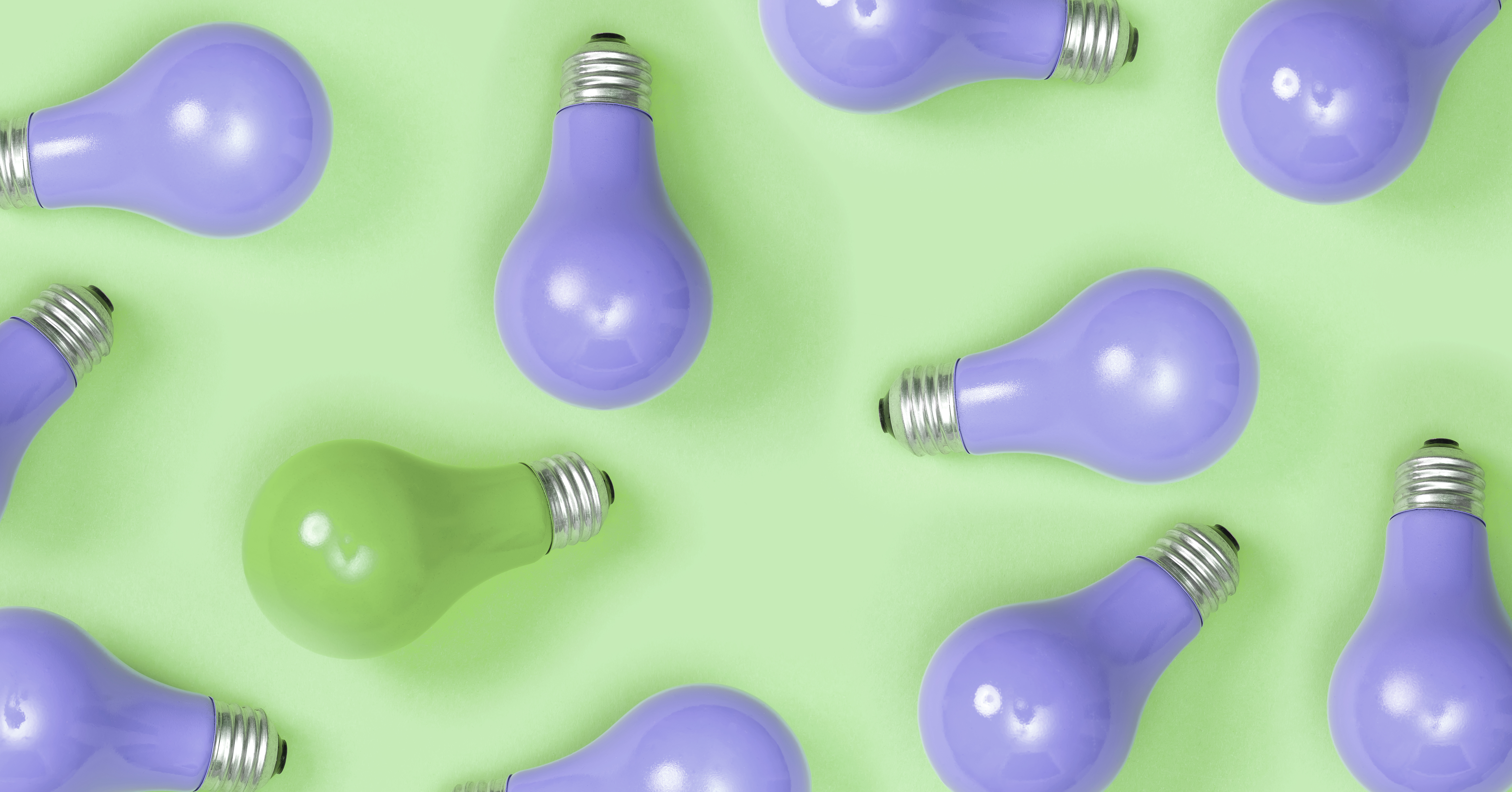 Purple painted lightbulbs Purple painted lightbulbs on a green background, wil one green