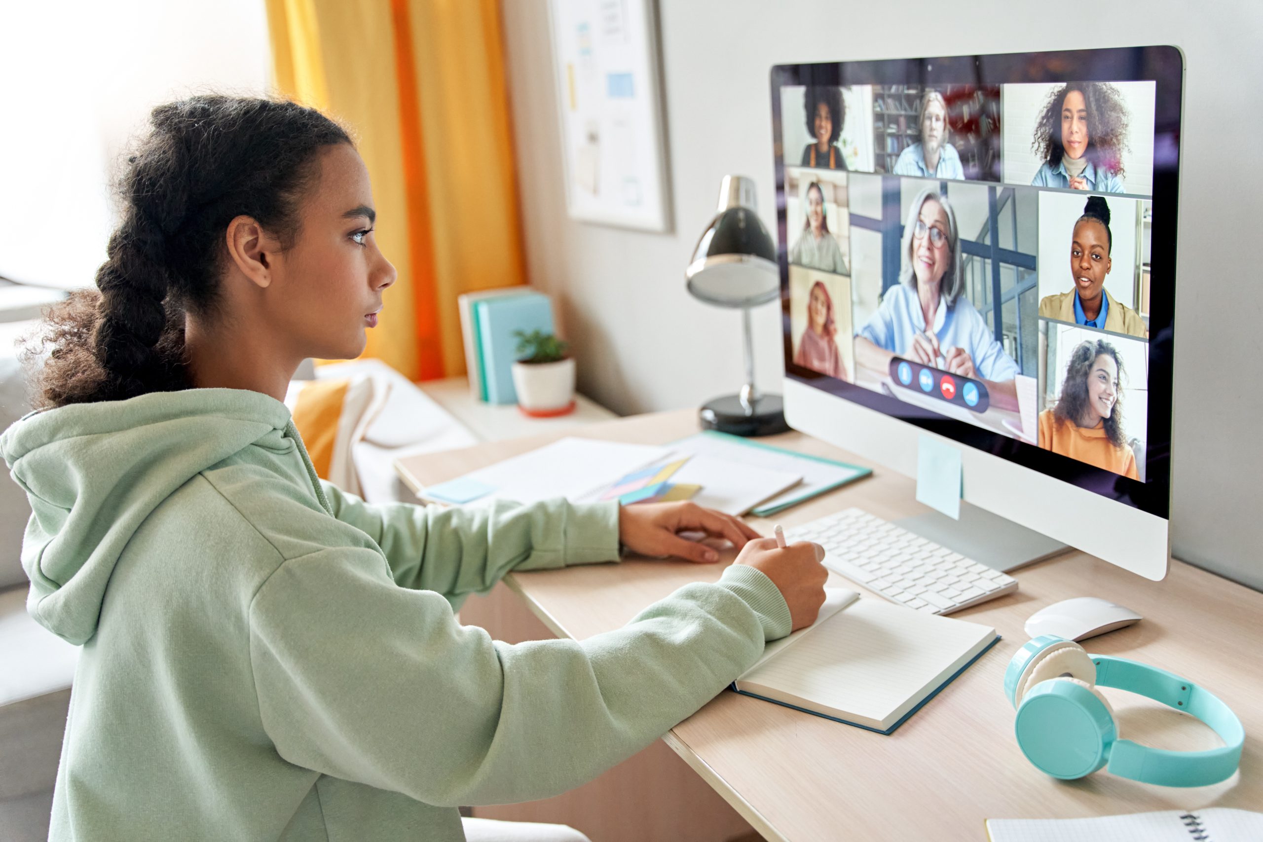 Mixed race teen school girl remote learning during online group class. young person on a zoom call